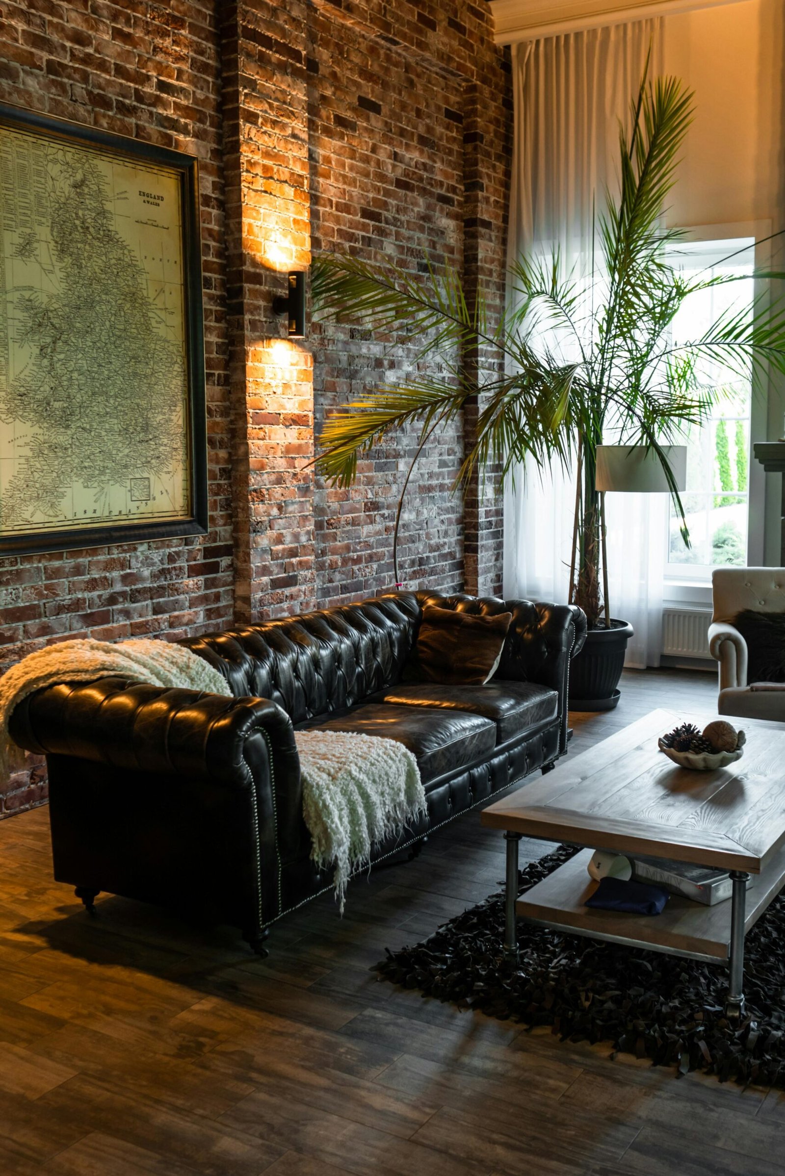 brick wall living room with tufted sofa dark photo
