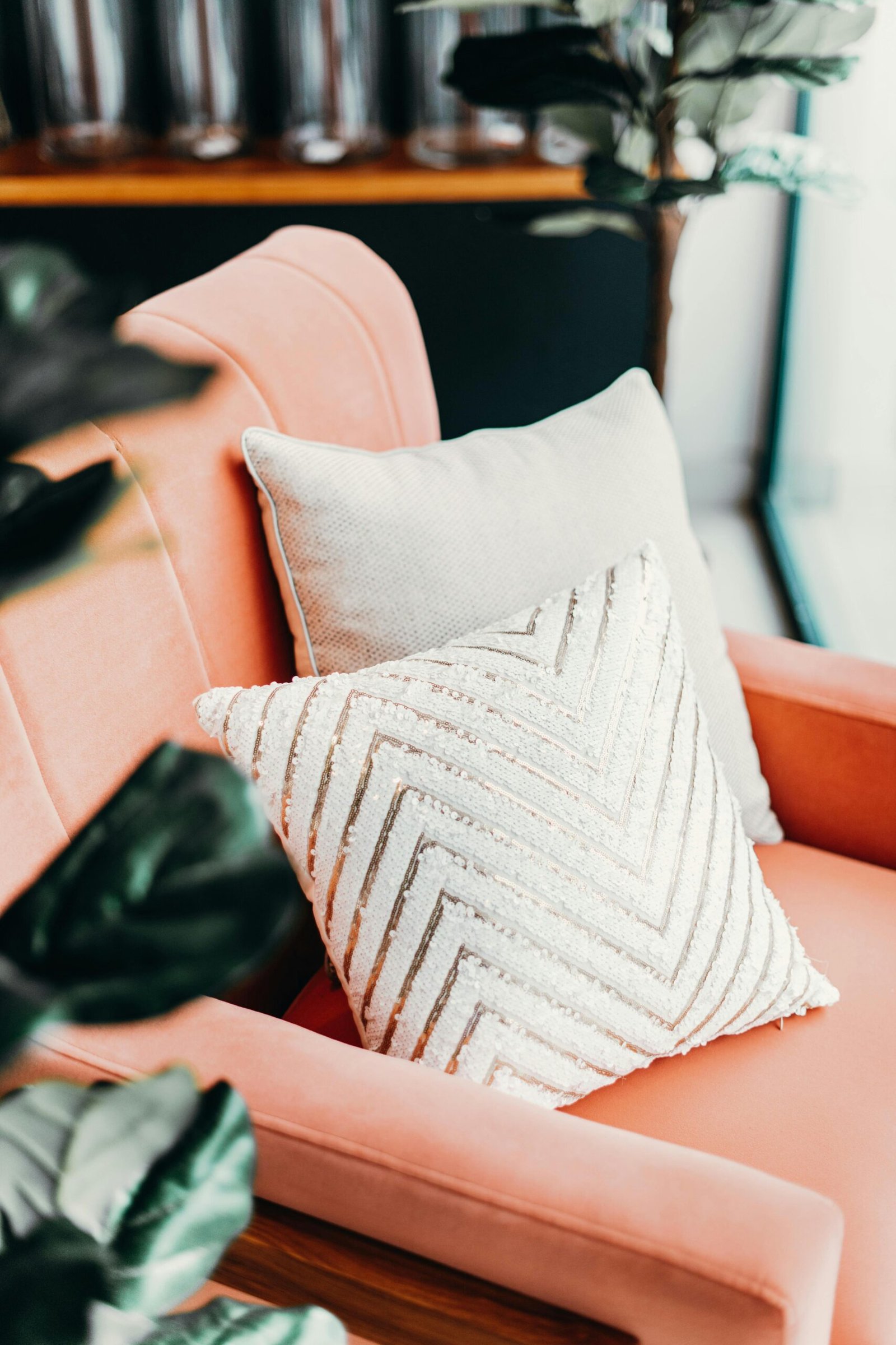 A stylish armchair adorned with elegant throw pillows, creating a cozy indoor atmosphere.